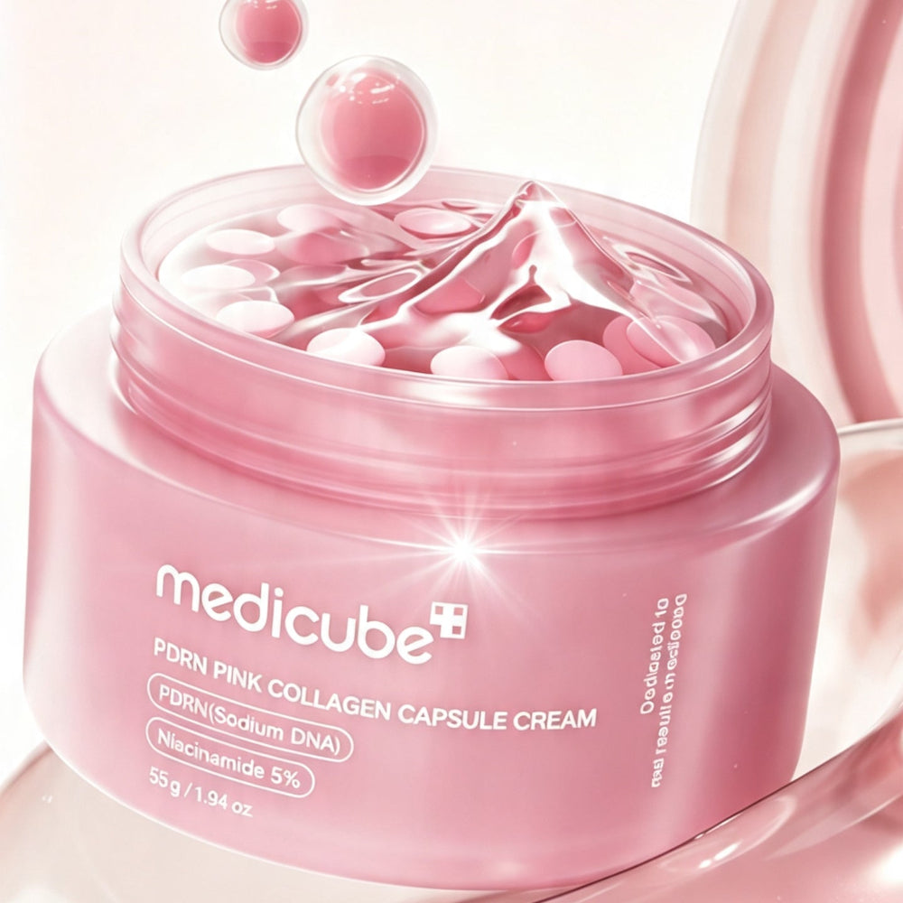 A pink cosmetic jar labeled medicube PDRH Pink Collagen Capsule Cream, shown open with cream and capsules floating above it on a soft pink background.
